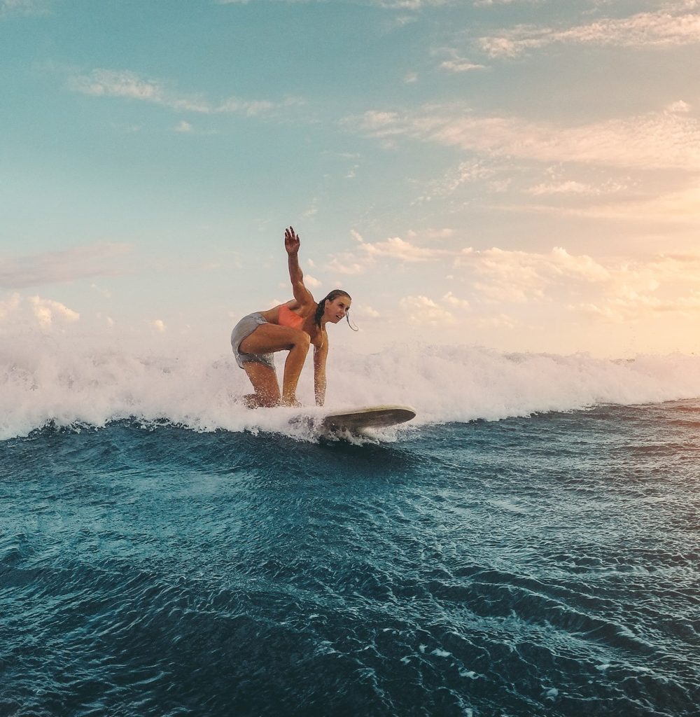 fit-female-athlete-surfing-at-sunset-surfer-woma-2025-02-21-16-31-32-utc-min